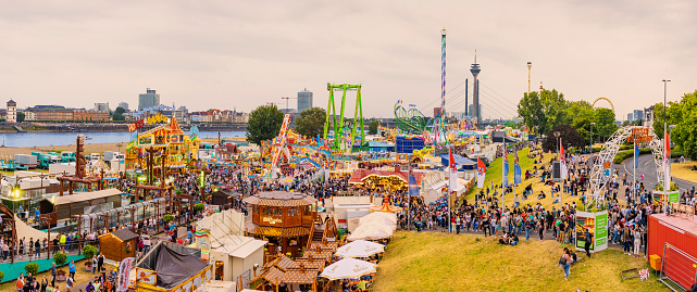 22 July 2022, Dusseldorf, Germany: An amusement fair and many eateries at a traditional festival on the banks of the Rhine river in Dusseldorf