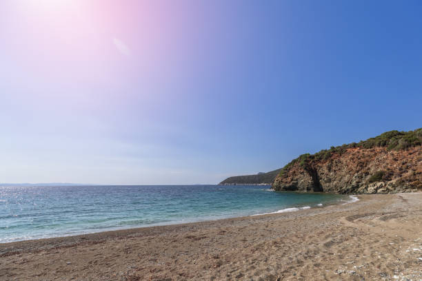 istock Meditative deserted sandy beach hidden from prying eyes somewhere on Sithonia cape at low tide and incandescent summer sun reaches its zenith, Toroni, Chalkidiki, Greece 1427924996