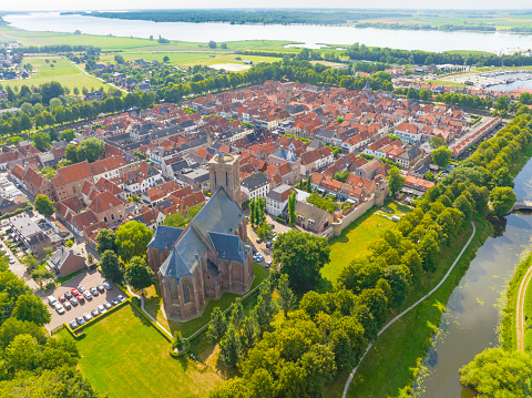 Elburg ancient walled town seen from above during a beautiful summer day in Gelderland, Netherlands. Elburg used to be a fishing town, but now is more focussed on tourism for its location close to the Veluwemeer and Veluwe as popular tourist destinations.
