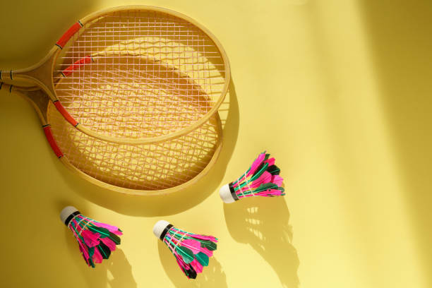 istock Shuttlecock and badminton racket on pastel color yellow background. Flat lay 1427930391