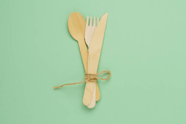 istock Tableware wooden cutlery on a green background. View from above, plastic rejection concept, zero waste. Copy space 1427930546