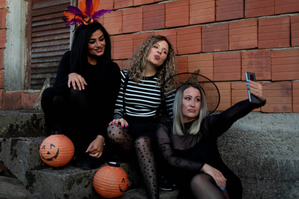 istock Women sit on old concrete steps and take selfies. 1427934996