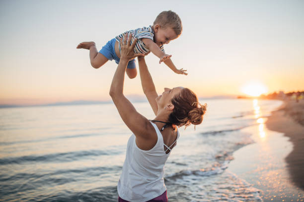 istock Mother and son playing on the beach during the sunset 1427936651