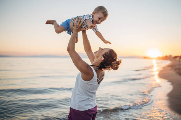 istock Mother and son playing on the beach during the sunset 1427936717