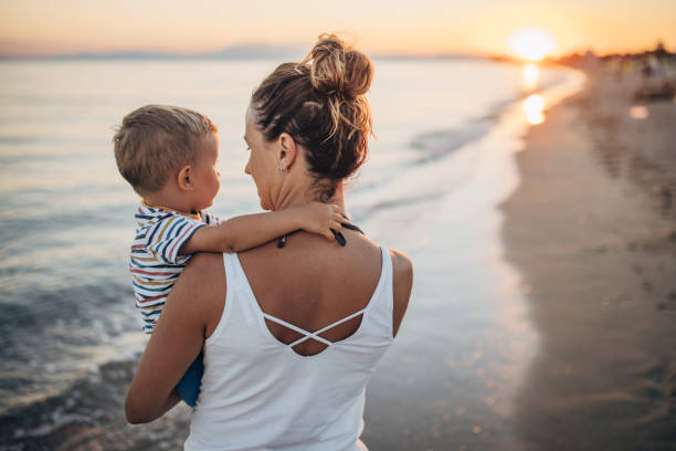 istock Mother and son on the beach during the sunset 1427936769