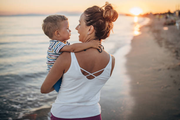 istock Mother and son on the beach during the sunset 1427936807