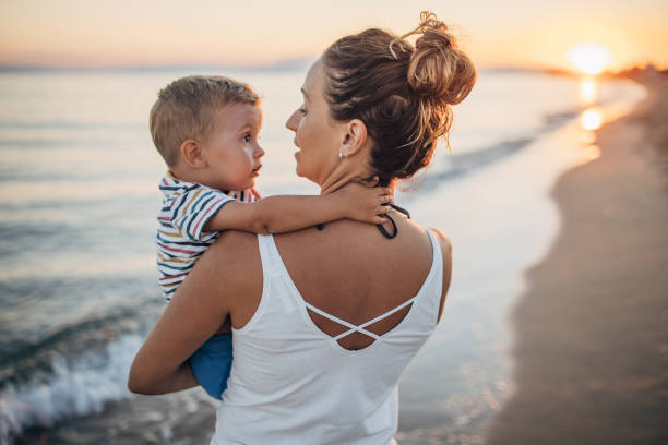 istock Mother and son on the beach during the sunset 1427936830