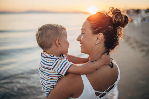 istock Mother and son on the beach during the sunset 1427936848