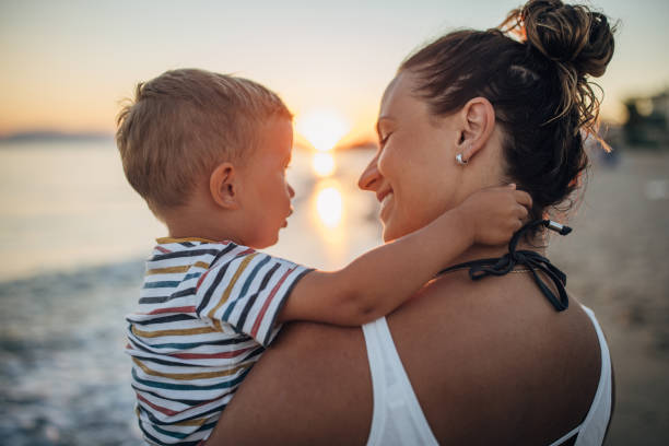 istock Mother and son on the beach during the sunset 1427937013