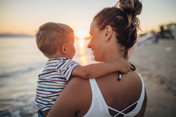 istock Mother and son on the beach during the sunset 1427937055
