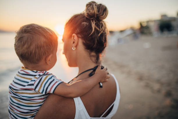 istock Mother and son on the beach during the sunset 1427937195