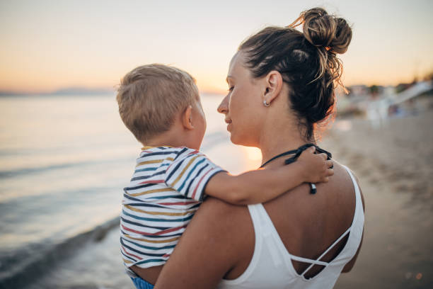 istock Mother and son on the beach during the sunset 1427937299