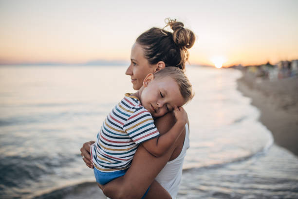 istock Mother and son on the beach during the sunset 1427939373
