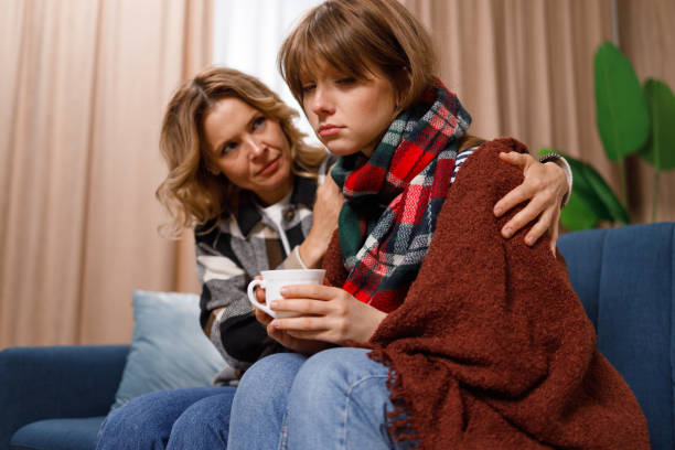 istock Caring mother supporting her daughter who got the flu 1427939395