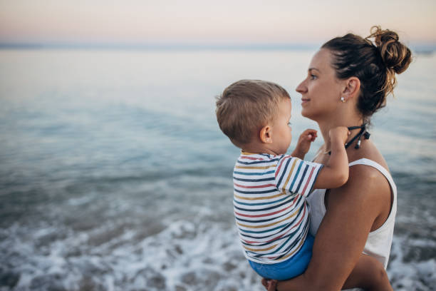 istock Mother and son on the beach during the sunset 1427939456