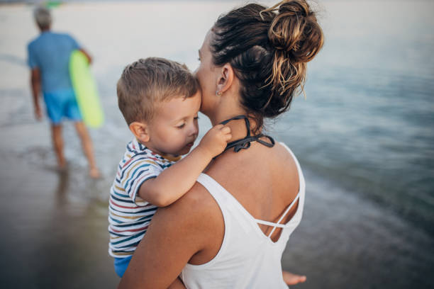 istock Mother and son on the beach during the sunset 1427939503