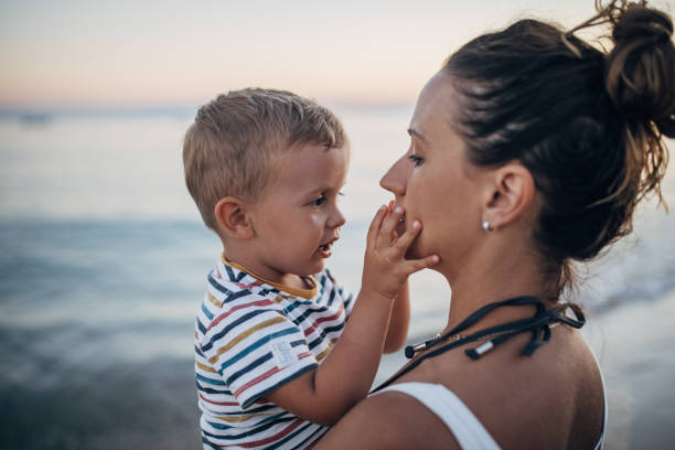 istock Mother and son on the beach during the sunset 1427939664
