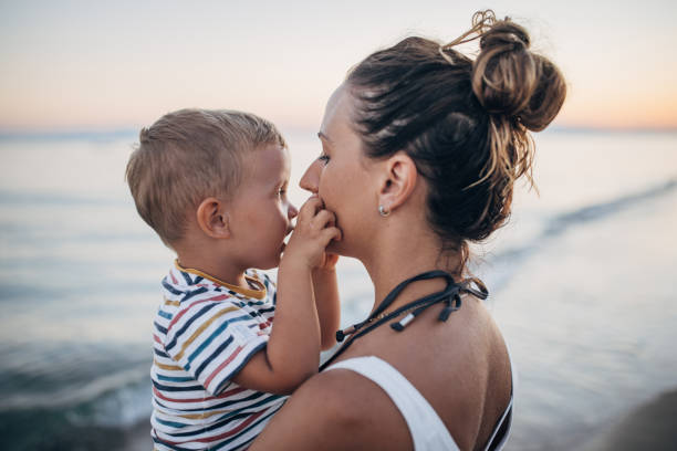 istock Mother and son on the beach during the sunset 1427939694