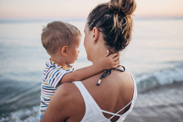 istock Mother and son on the beach during the sunset 1427939731