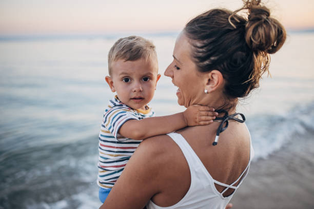 istock Mother and son on the beach during the sunset 1427939760
