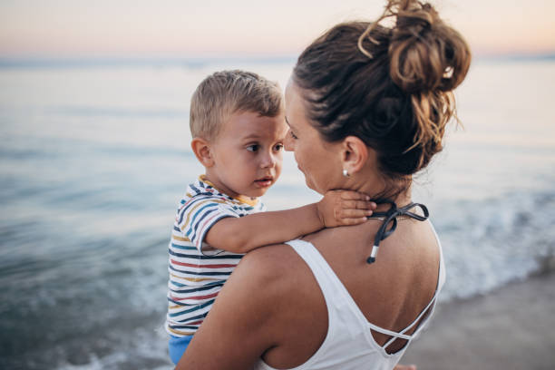 istock Mother and son on the beach during the sunset 1427939802