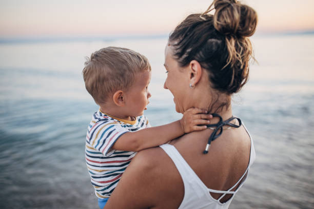 istock Mother and son on the beach during the sunset 1427939929