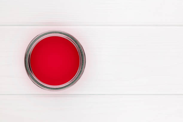 istock open can with red paint on a white wooden background top view with copy space 1427940856