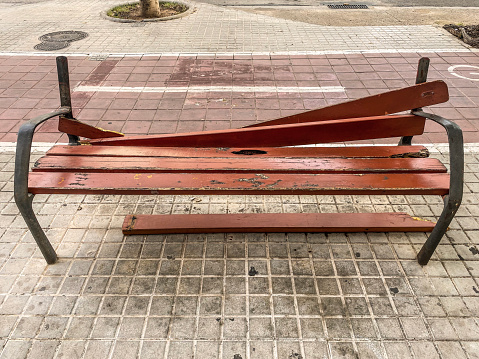 High angle view of broken wood bench in the street in the city of Valencia, Spain