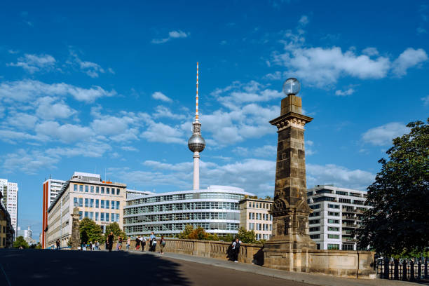 Berlin, Germany - September 03, 2022: People walking on the Friedrichs bridge (German: Friedrichsbruecke), Television Tower seen on the background.