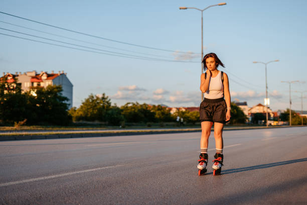 istock Young Woman Roller Skating Down The Street 1427948912