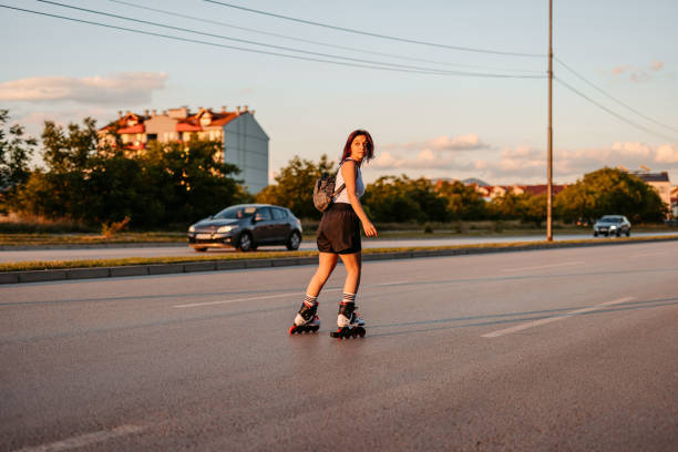 istock Young Woman Roller Skating Down The Street 1427948979