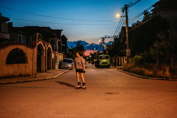 istock Young Woman Roller Skating In A Downtown District At Night 1427949322