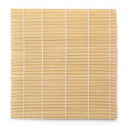 Bamboo makisu isolated on a white background. Sushi mat cutout. Square wooden mat used for forming rolls of sushi. Japanese kitchen utensil for preparing makizushi. Top view.
