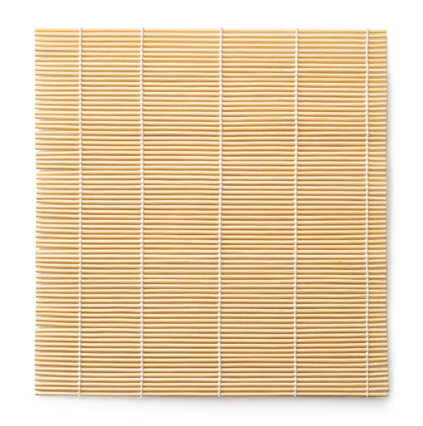 Bamboo makisu isolated on a white background. Sushi mat cutout. Square wooden mat used for forming rolls of sushi. Japanese kitchen utensil for preparing makizushi. stock photo