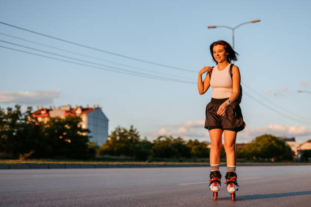 istock Young Woman Roller Skating Down The Street 1427950922