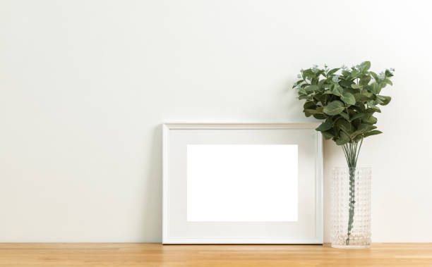 istock Style picture frame still life put on the wooden table. Blank space empty picture frame with mockup. Shot in studio with natural light. Template background interior design and decoration. 1427951215
