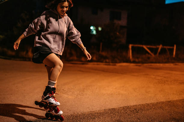 istock Young Woman Roller Skating In A Downtown District At Night 1427951336
