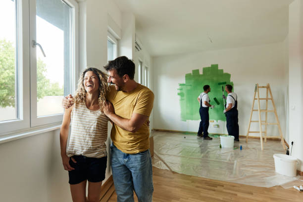 pareja alegre durante su proceso de renovación del hogar. - home improvement couple painting real estate fotografías e imágenes de stock