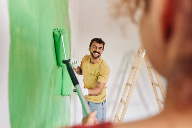 istock Happy couple talking while painting their new apartment. 1427952677