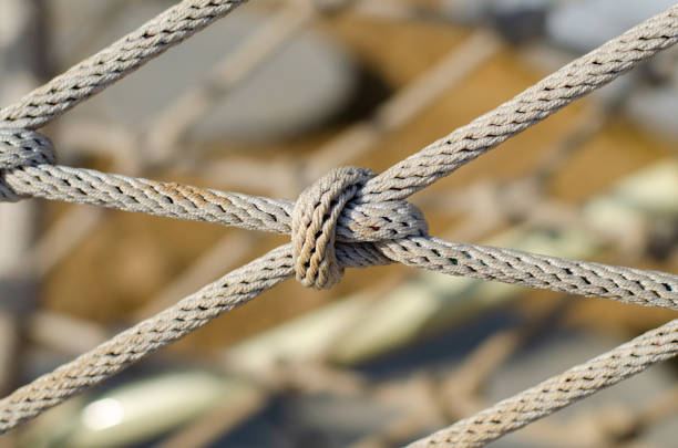 istock Mesh from an old rope. Climbing rope. Marine knot on a ship. Decorative fencing. Fishnet. 1427952921