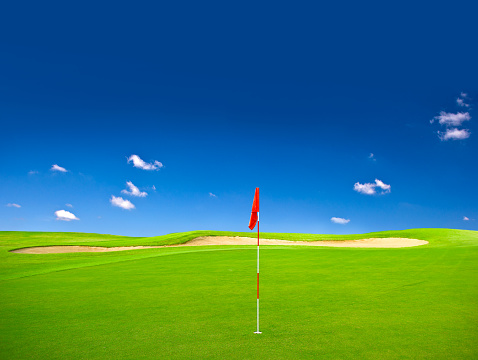 Green field golf club course with blue sky. Nature landscape background