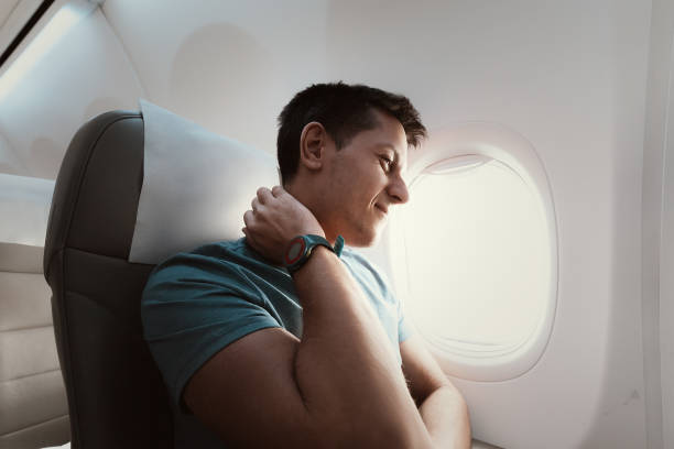 istock A man suffers from severe neck pain during a long flight in an uncomfortable position on an airplane. Osteochondrosis symptoms and causes 1427953421