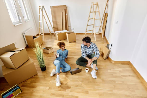 istock Relaxed couple talking on a break at their new apartment. 1427953792