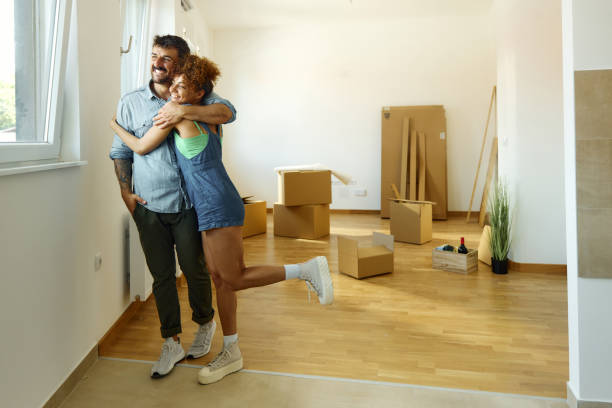 istock Happy couple embracing after relocating into a new apartment. 1427954432