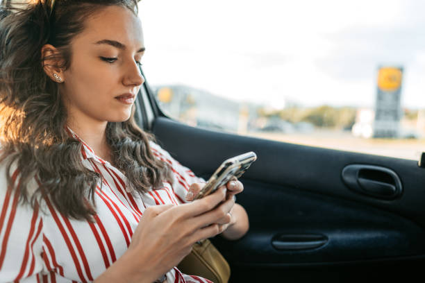 istock Young Woman Text Messaging In A Car 1427955128
