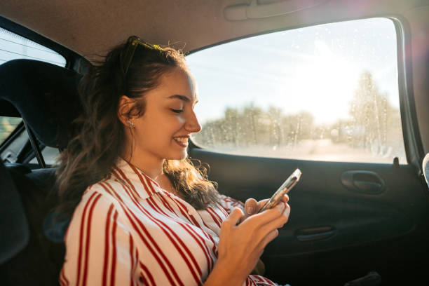 istock Young Woman Text Messaging In A Car 1427955164
