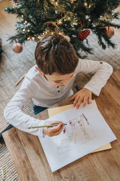 istock Boys drawing on Christmas card 1427956455