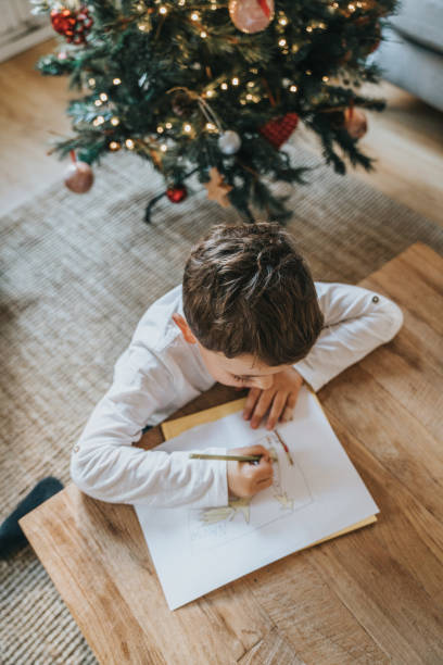 istock Boys drawing on Christmas card 1427956465