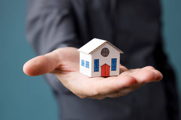 istock Model house in man hand 1427957315