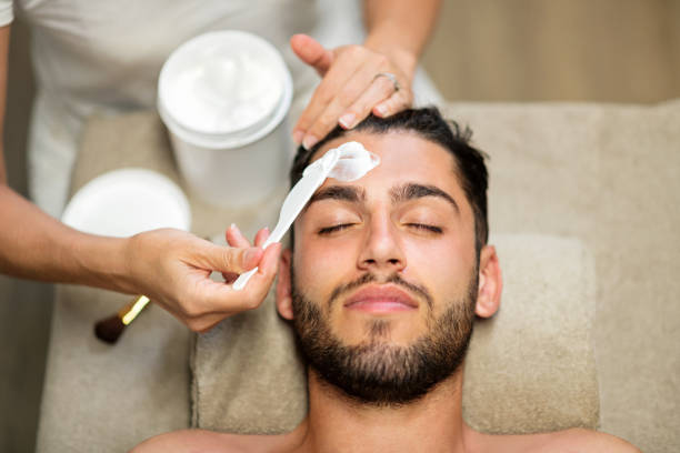 istock Cosmetician doing purifying face treatment for man 1427959526
